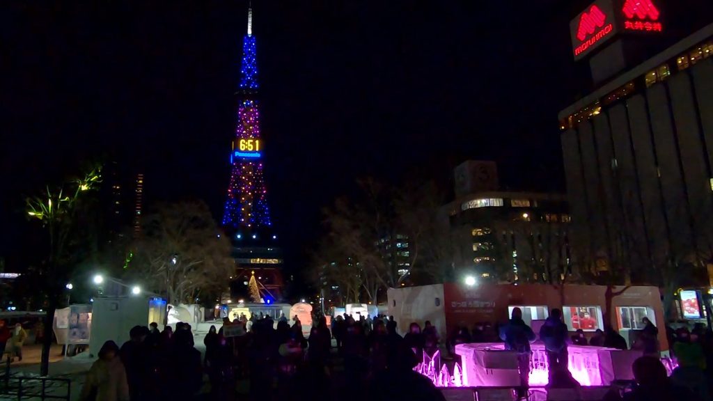 Sapporo TV Tower lights up in synchronisation with the ice marimba; a crowd gathers